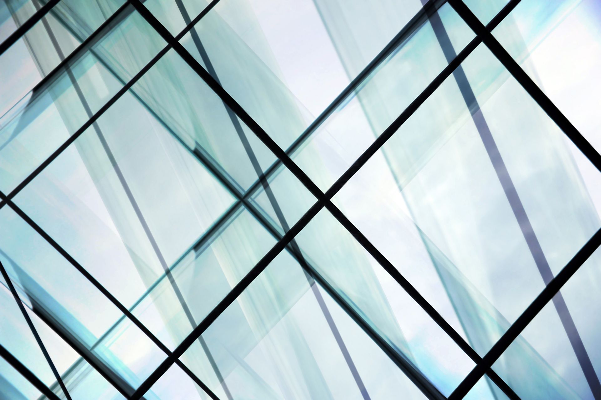 Abstract of intersecting glass panels, modern architecture, blue and white hues, black lines.