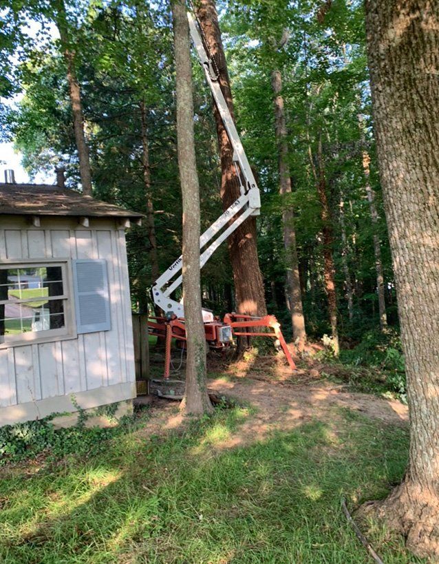 Small white shed next to aerial lift — Daniels, WV — Mastiff Lawn & Tree Care