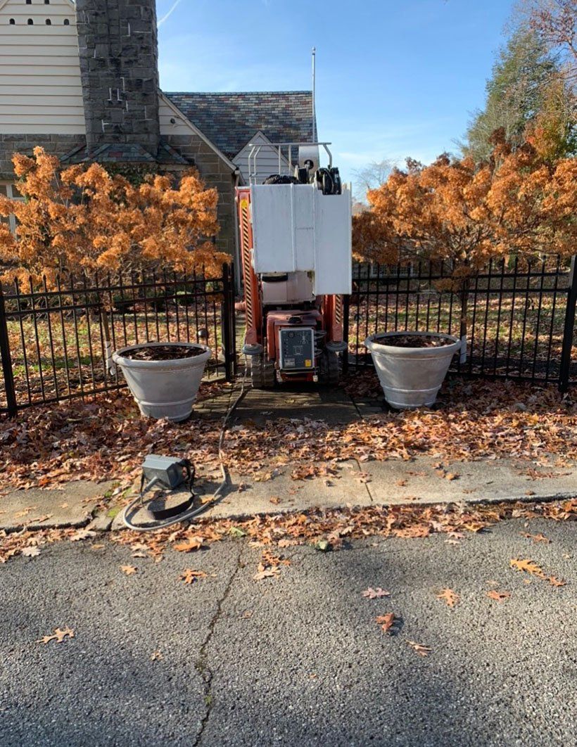 Two pots next to equipment and autumn leaves — Daniels, WV — Mastiff Lawn & Tree Care