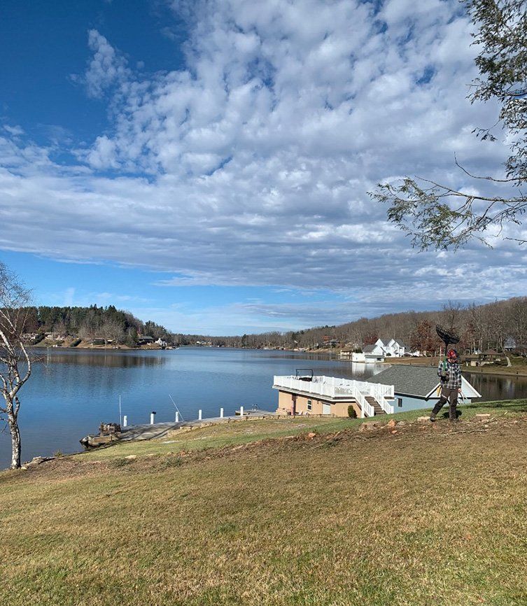 Nice small dock and fishing spot in front of river — Daniels, WV — Mastiff Lawn & Tree Care