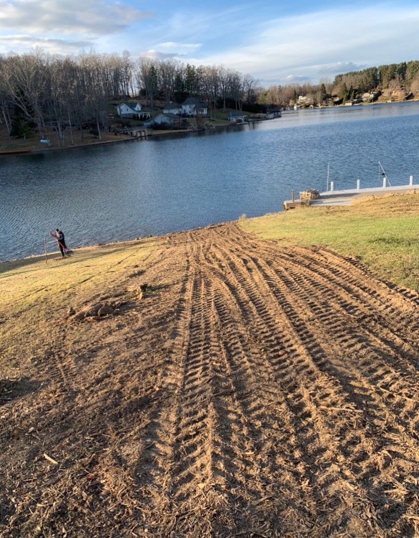 Path with many tire tracks leading to river — Daniels, WV — Mastiff Lawn & Tree Care