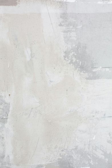 Gray and white abstract wall with patches and textures.