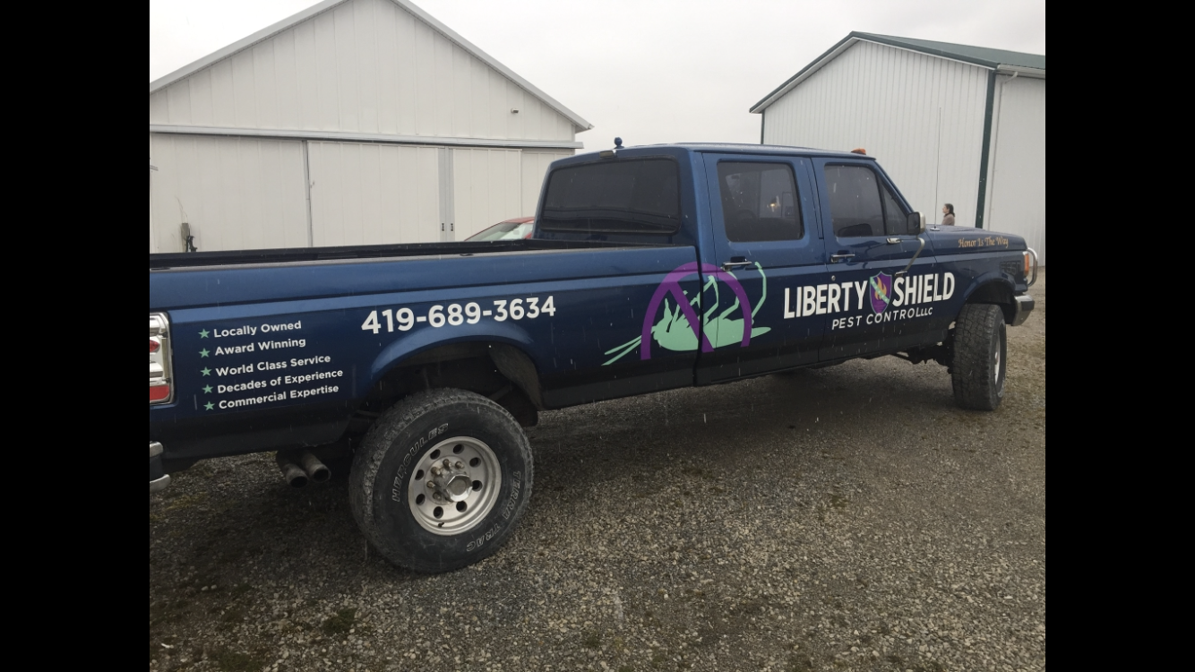 Blue pickup truck with business logo 