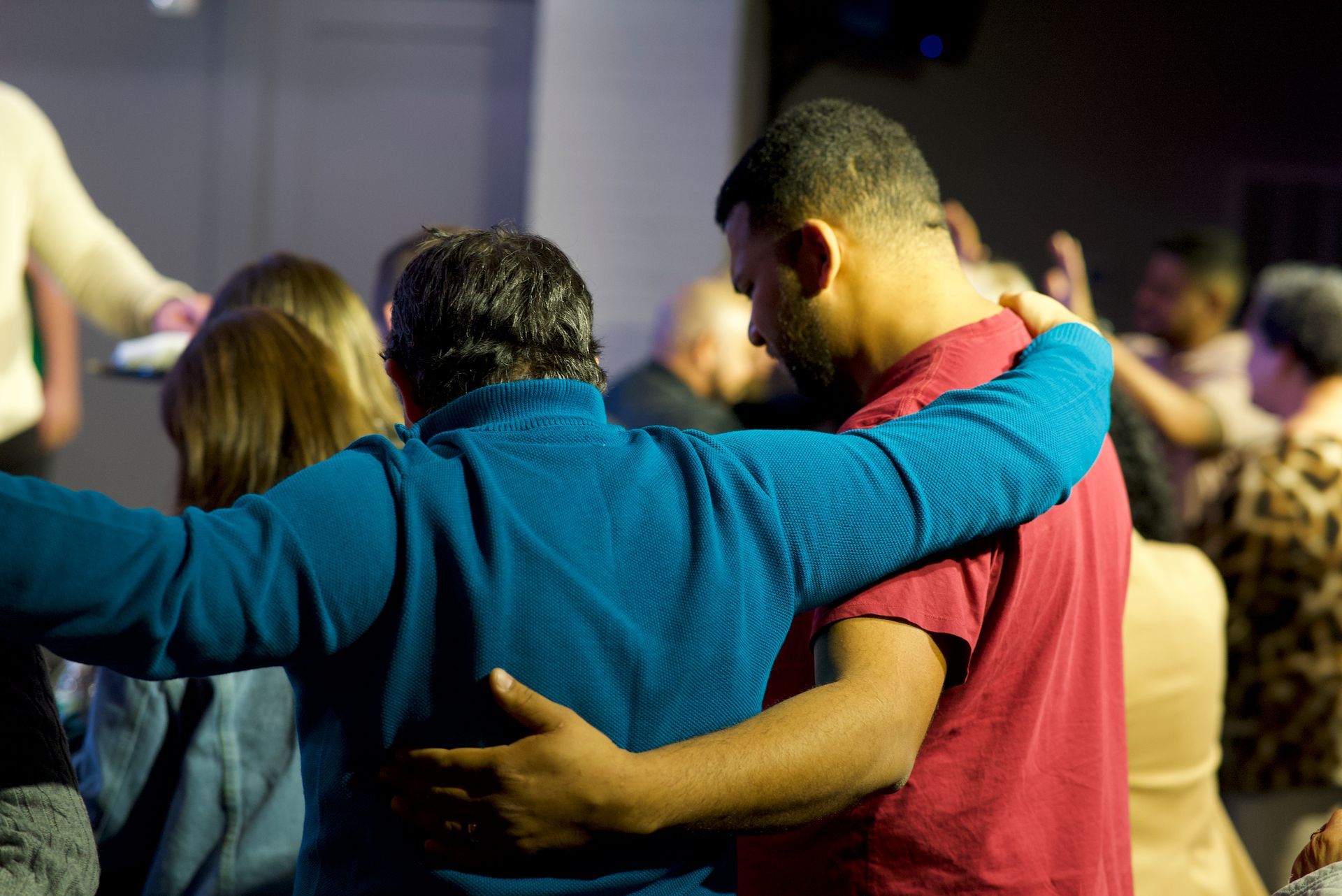 a group of people are hugging each other in a circle .