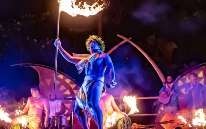 a statue of a woman holding a flag is surrounded by flames .