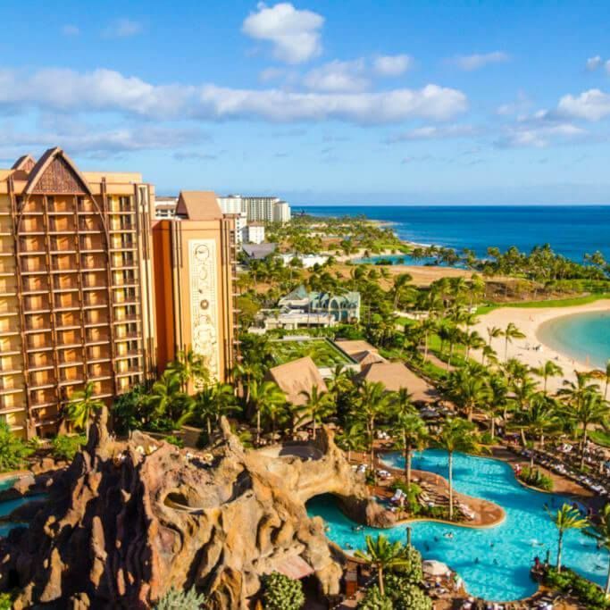 an aerial view of a resort with a swimming pool and a beach .