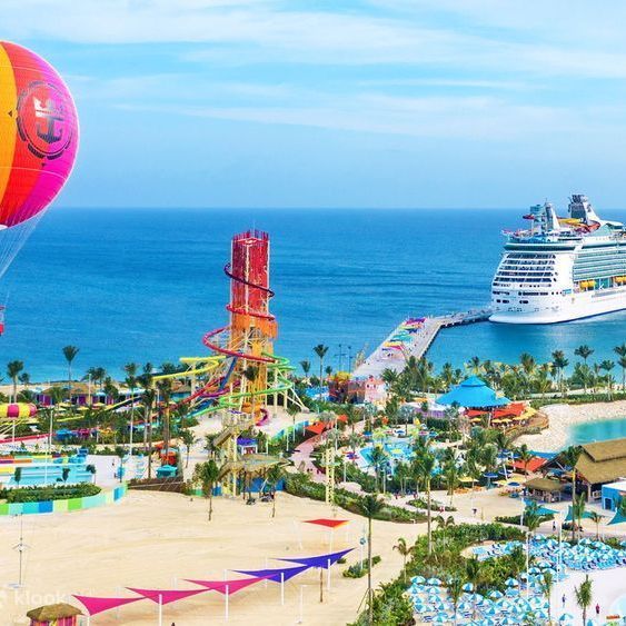 a cruise ship is docked at a pier on a beach .