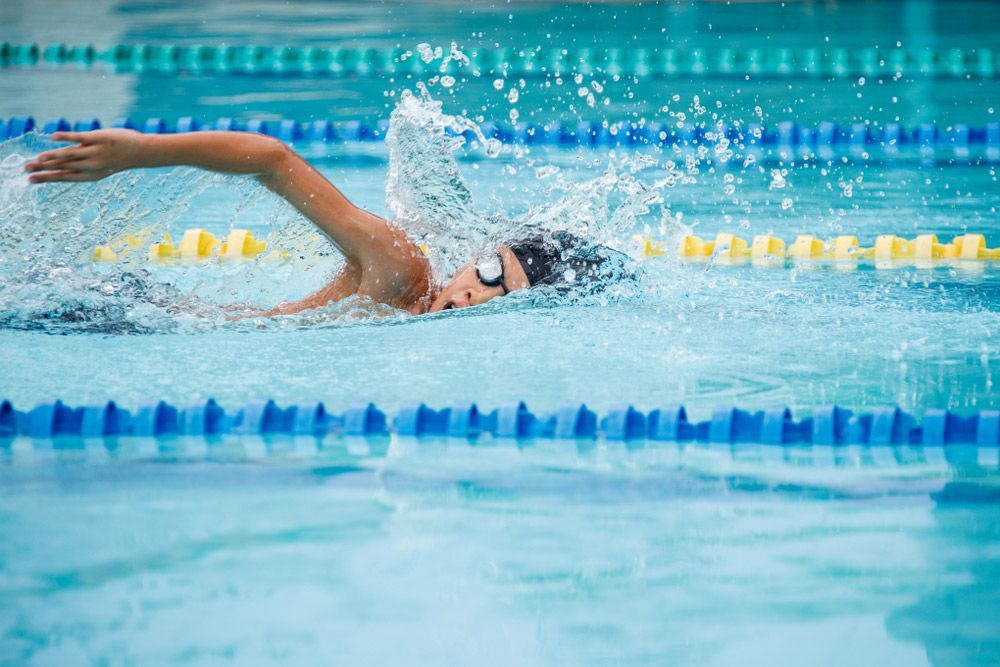 Happy Teenager Boy In A Swimming Pool