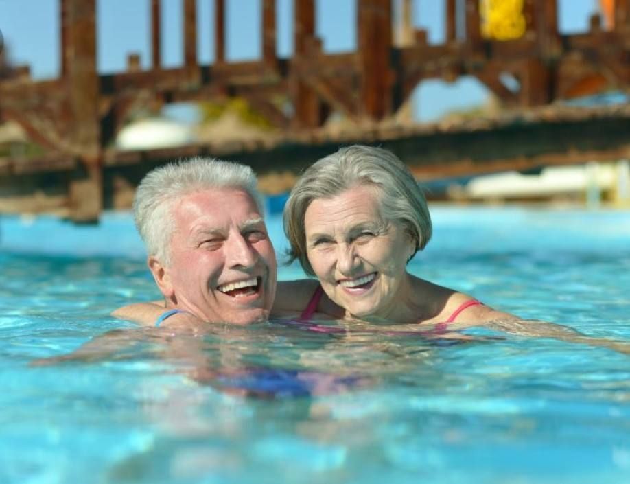 Old Couple Swimming In The Pool