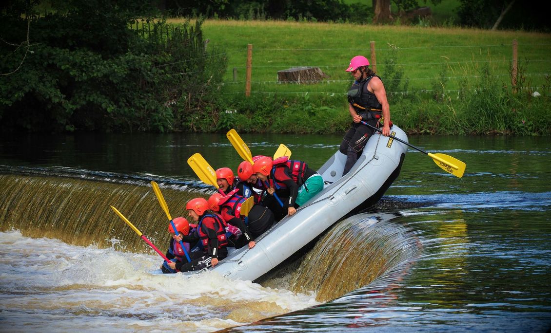 A group of people are riding a raft down a river.