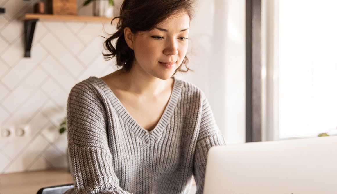 a woman signing a digital waiver on a computer