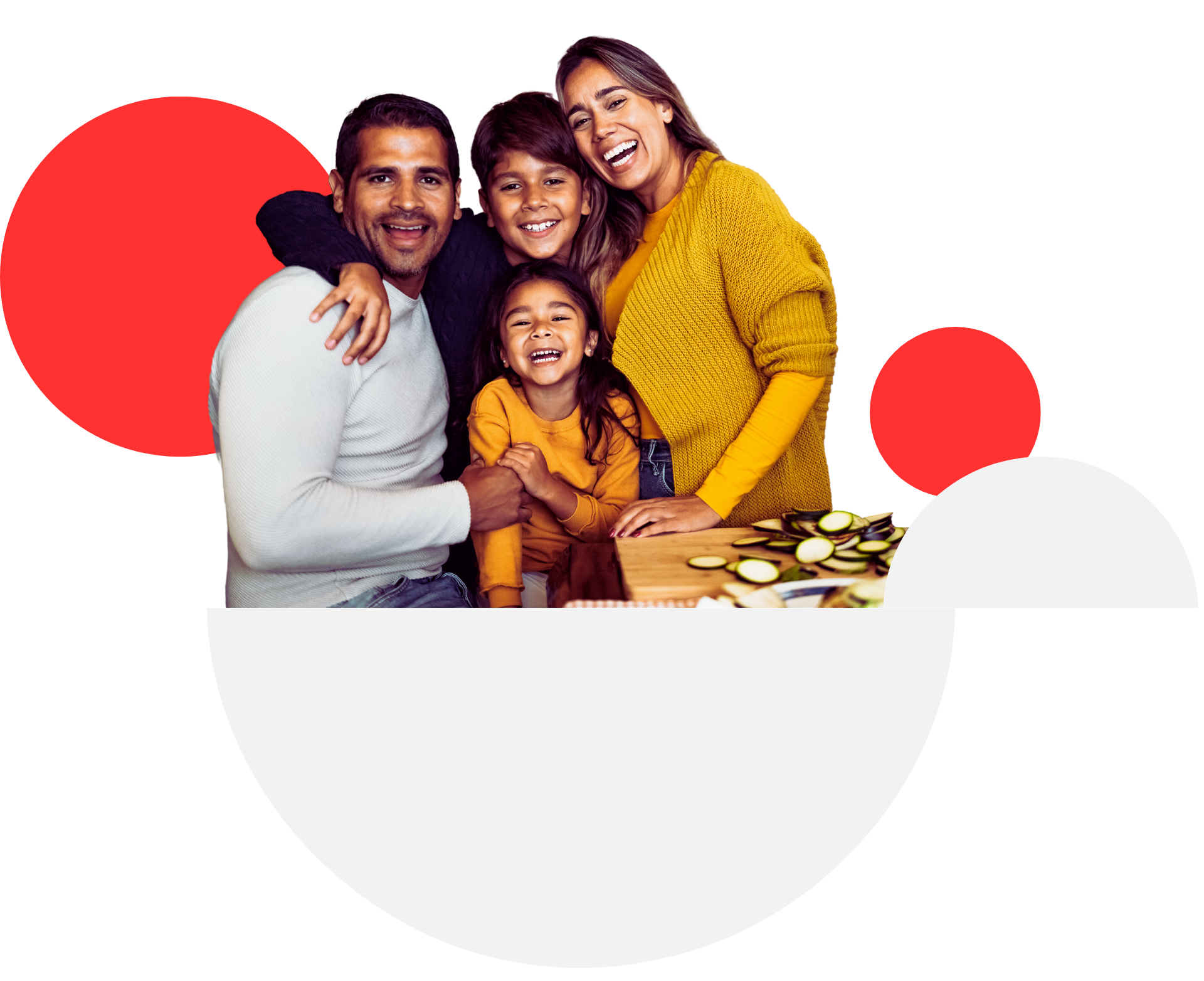 A family is posing for a picture while sitting at a table.