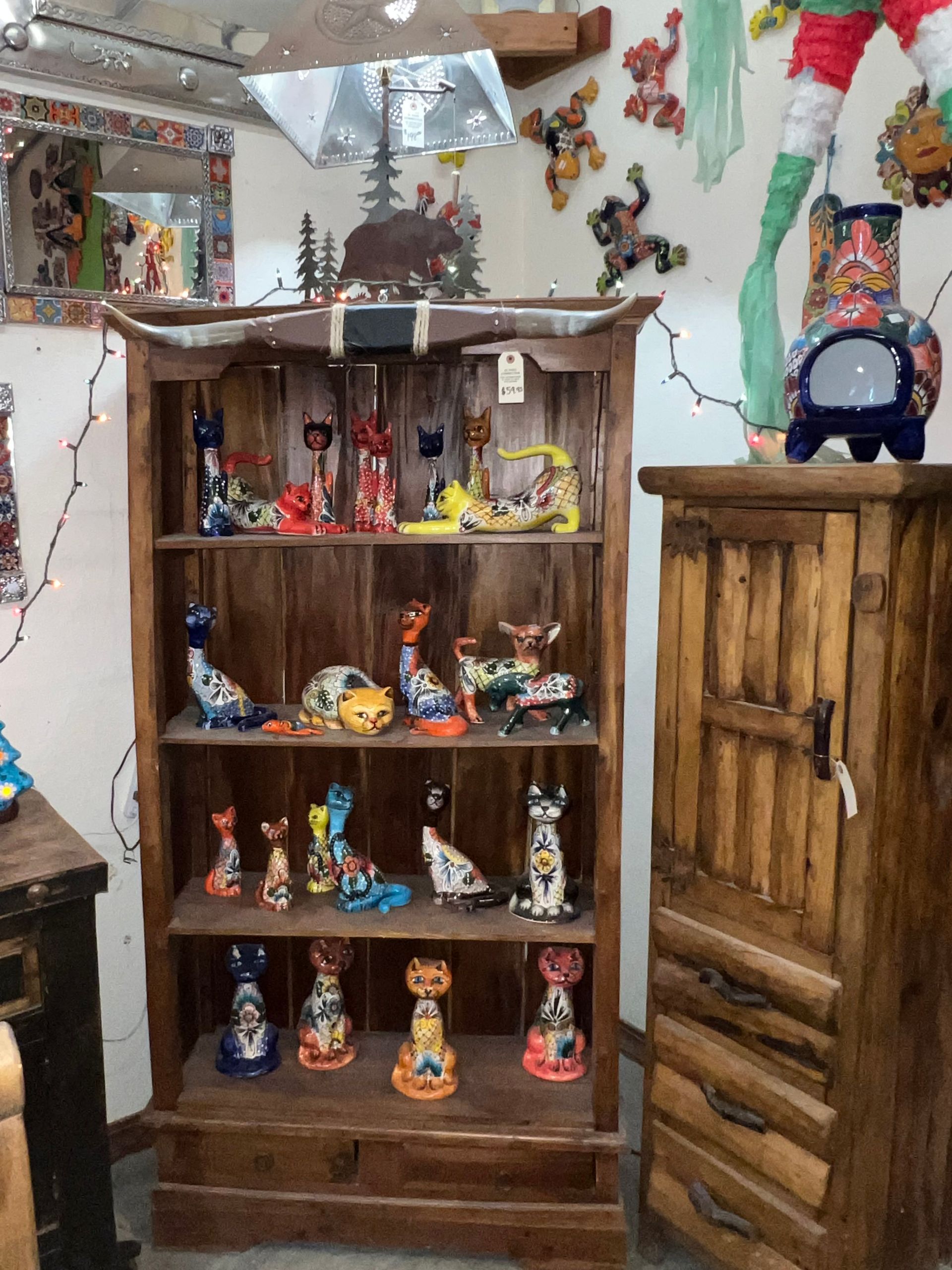 A wooden shelf with a lot of figurines on it