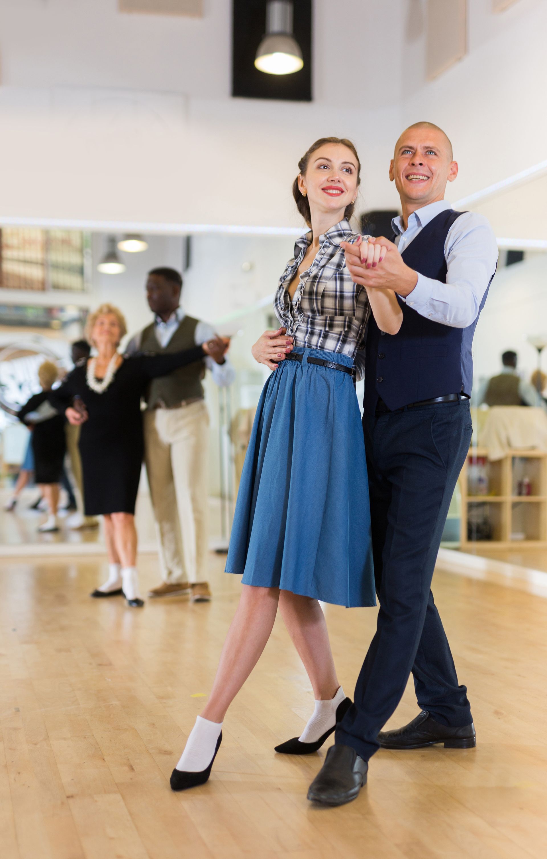 Happy couple enjoying elegant ballroom dancing.