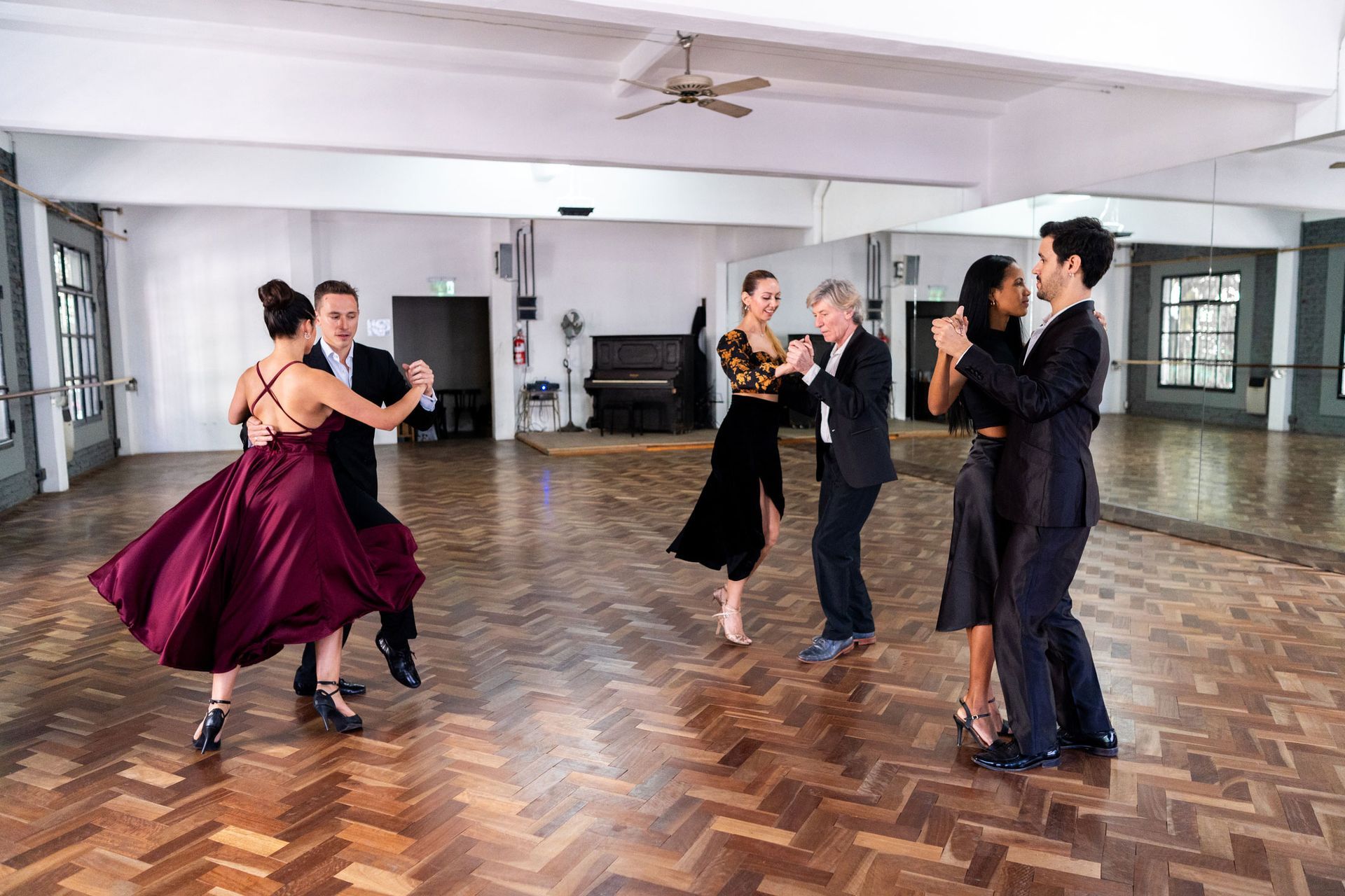 Tango dancers showcasing their skills at a professional ballroom dance class.