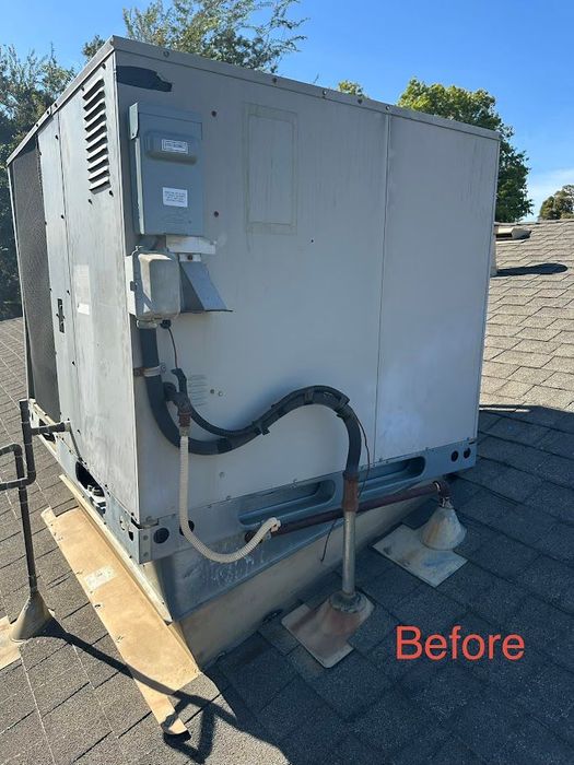 Gray rooftop HVAC unit with exposed cables and conduit on a wooden base, labeled “Before”