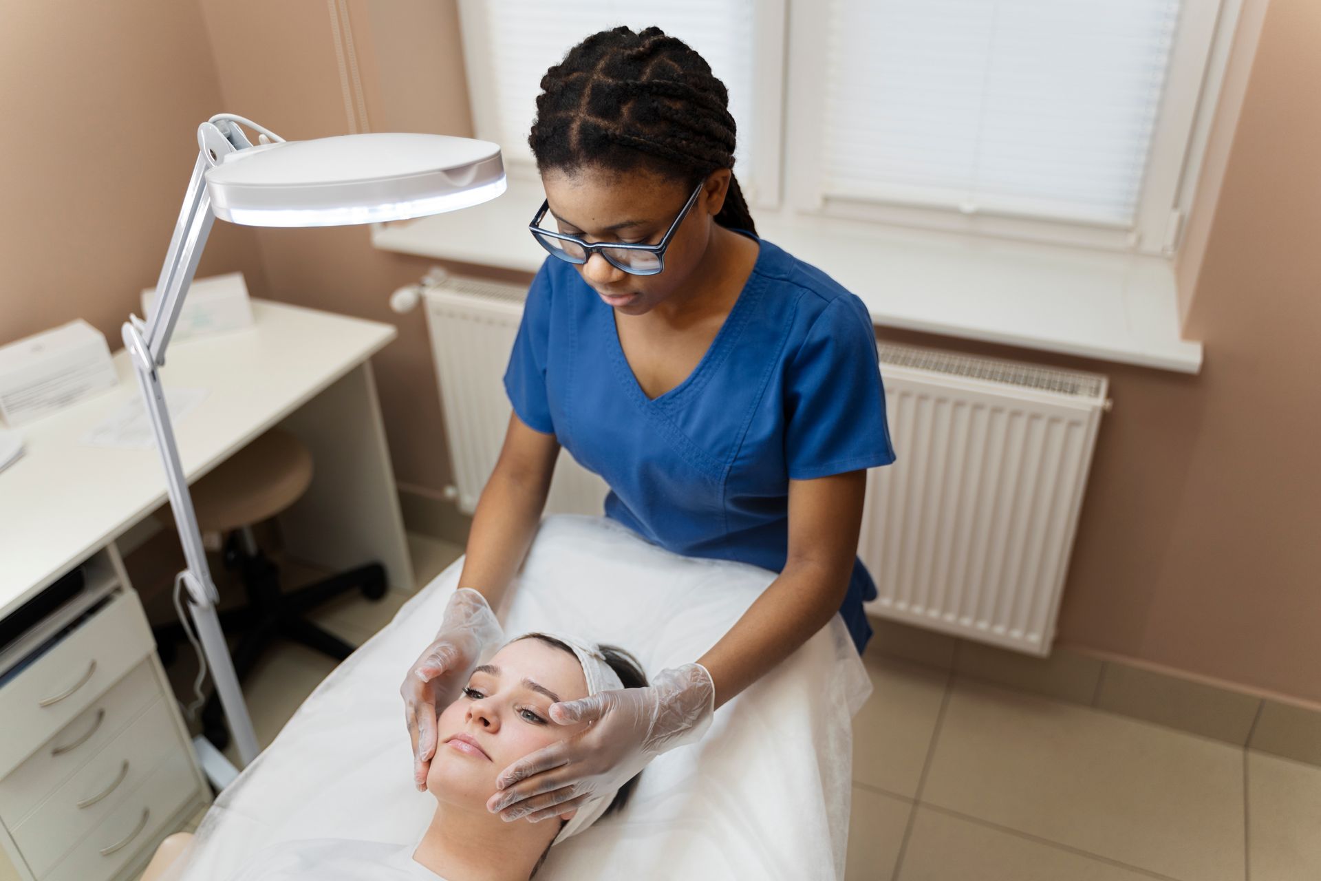 A woman is getting a facial treatment at a beauty salon.