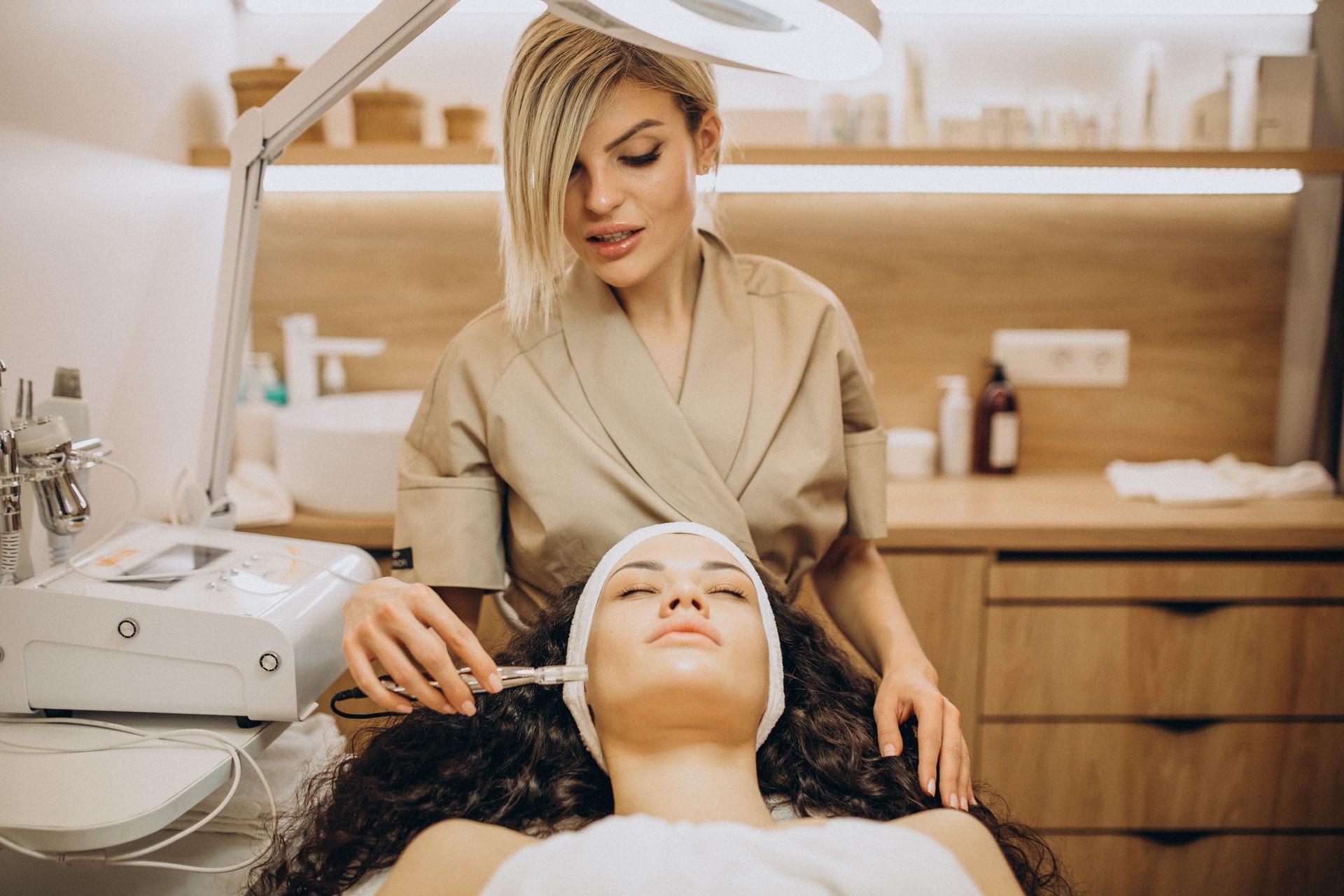 A woman is getting a facial treatment in a beauty salon.