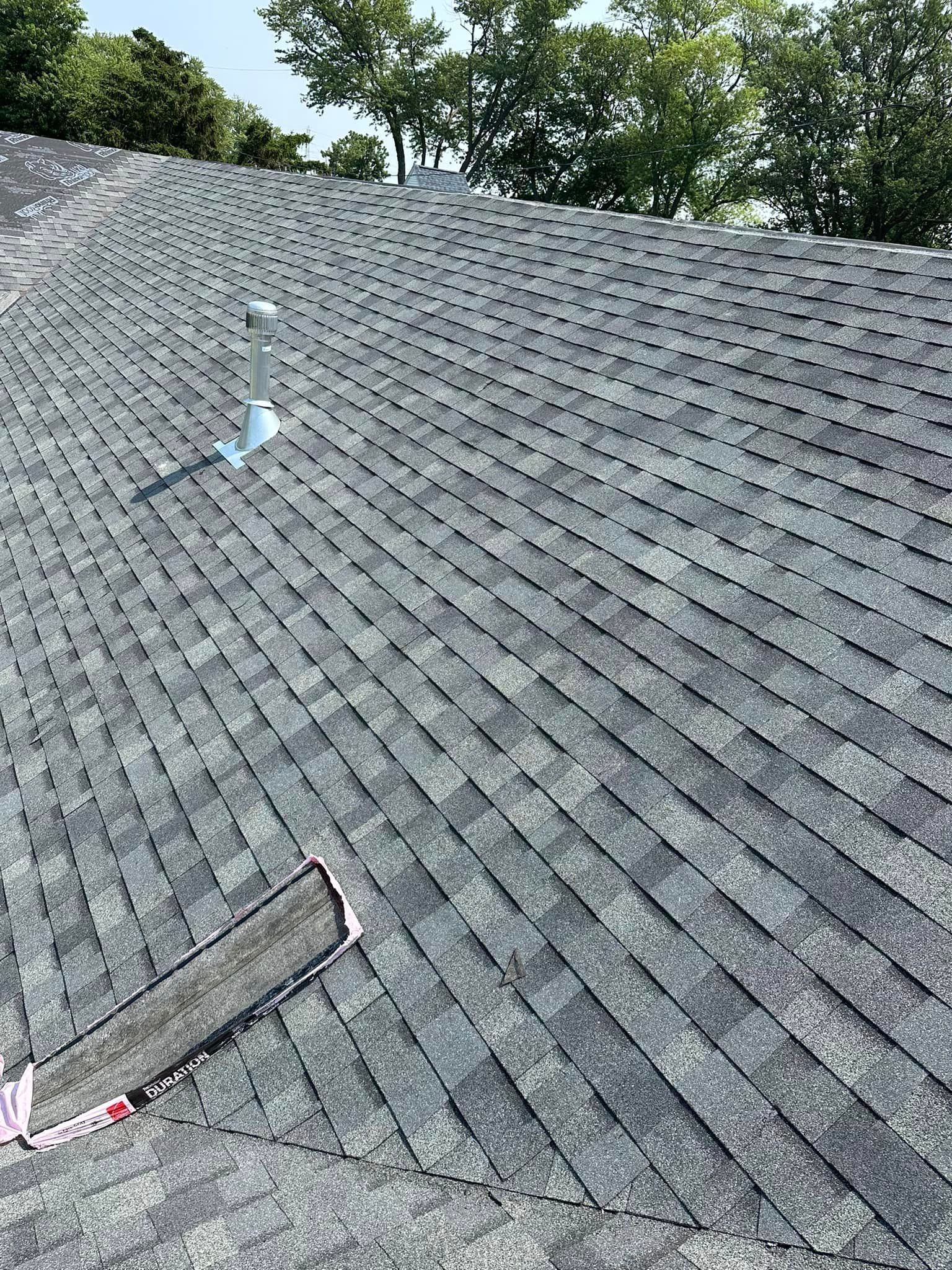 A Close Up Of A Roof With A Hole In It And Trees In The Background - Sandusky, OH - Petrick Roofing and Remodel LLC