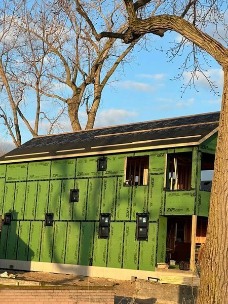 A Green House Is Being Built With A Tree In The Foreground - Sandusky, OH - Petrick Roofing and Remodel LLC