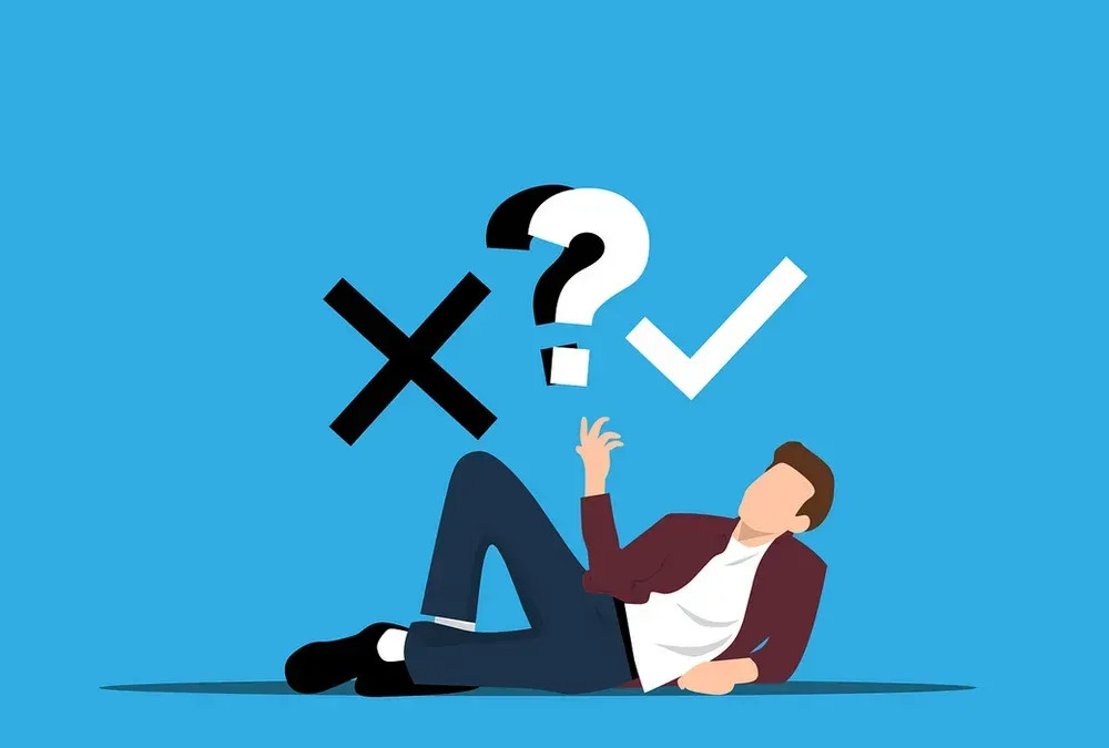 A man is laying on the floor with a question mark and a check mark above him.