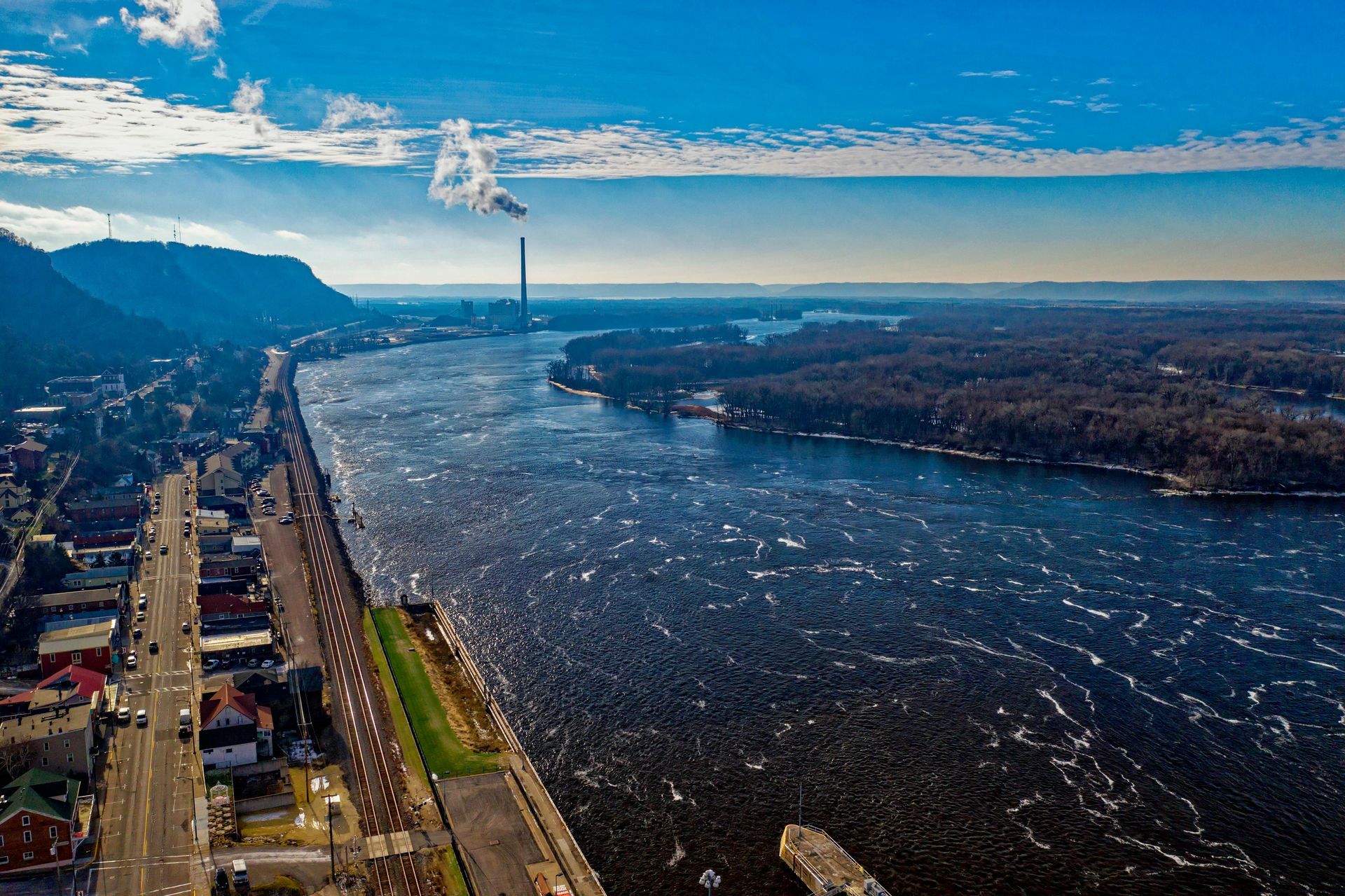An aerial view of a boat floating on top of a large body of water.