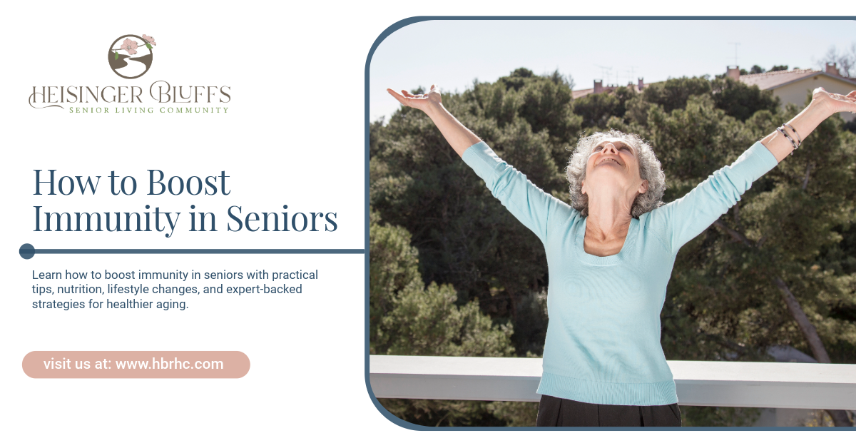 A senior stands outdoors with arms raised, looking up.