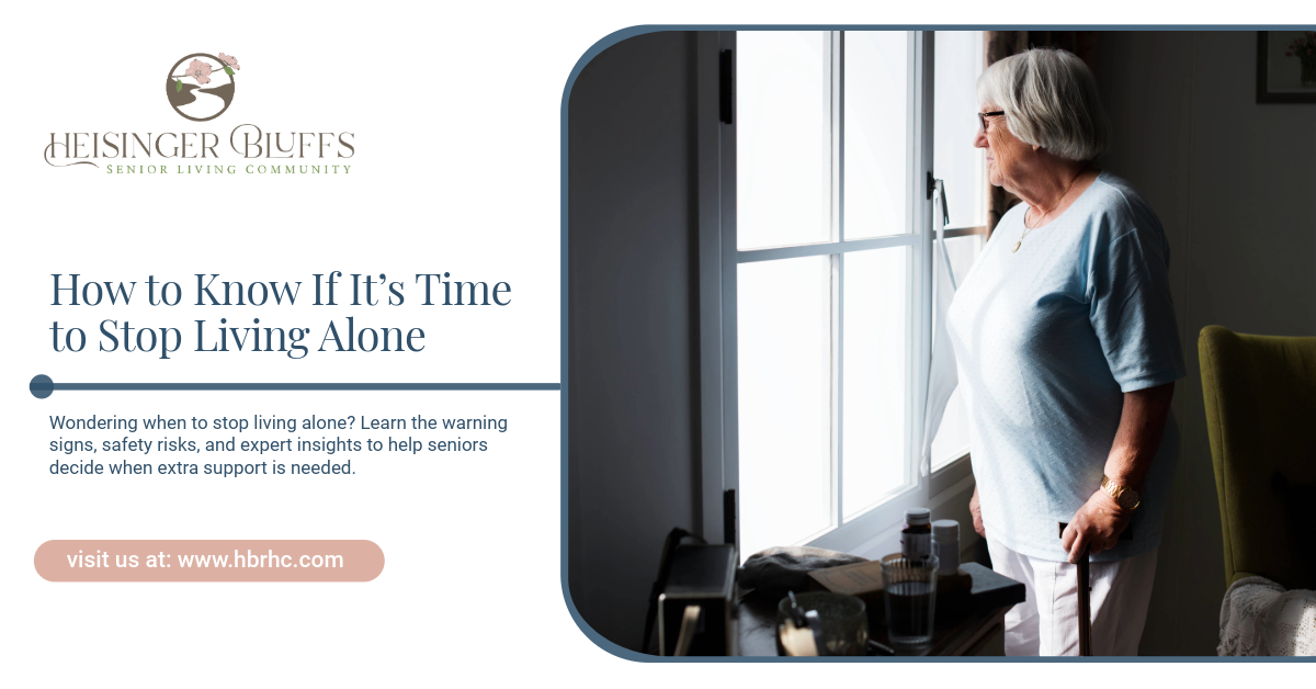 An elderly person living alone looks out a window. 