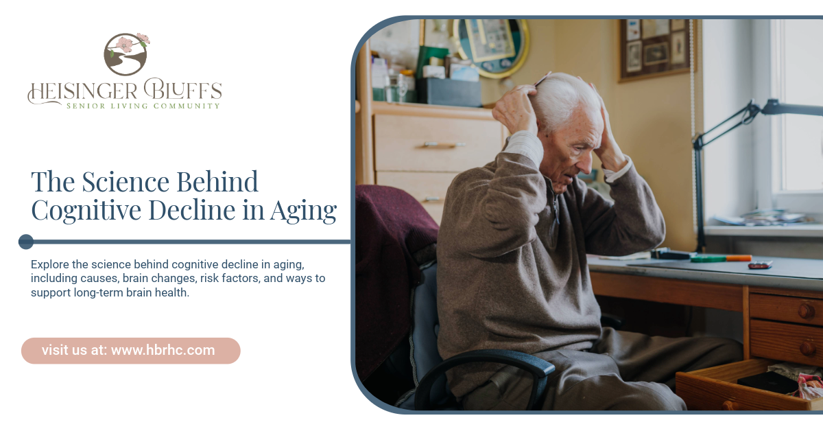 A senior sitting at a desk, holding his head, experiencing cognitive decline