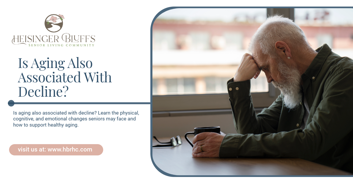 Elderly man with head in hands, looking down.