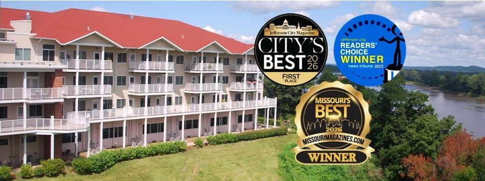 A large building with a red roof surrounded by trees