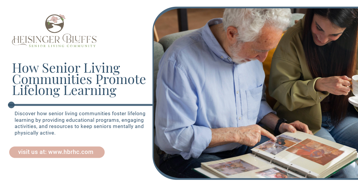 A man and a woman are sitting at a table looking at a photo album.