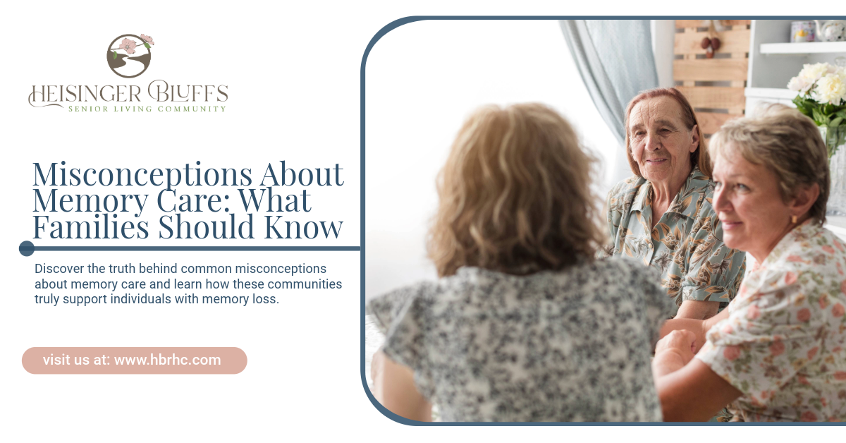 A group of older women are sitting around a table talking to each other in a memory care facility
