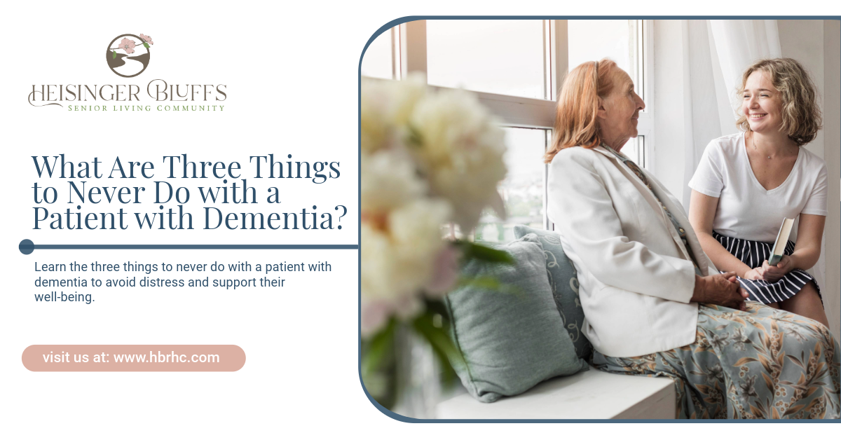 A patient with dementia and a caregiver are sitting next to each other on a couch