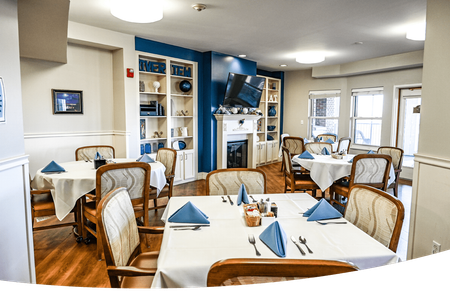 A large dining room with tables and chairs