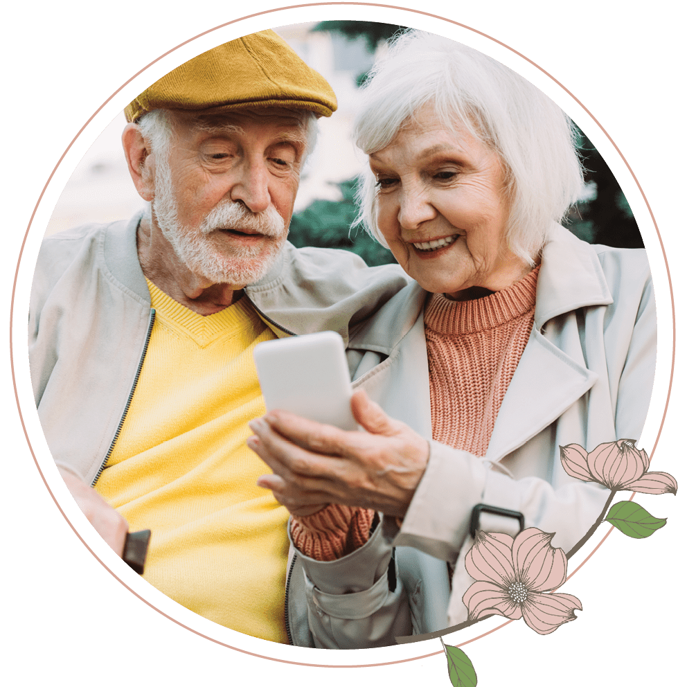 An elderly couple looking at a cell phone together 