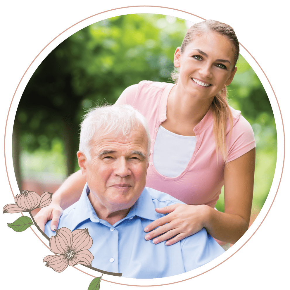 A woman posing for a photo with an older man in a wheelchair 