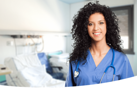 A nurse smiling in a hospital room with a stethoscope around her neck 