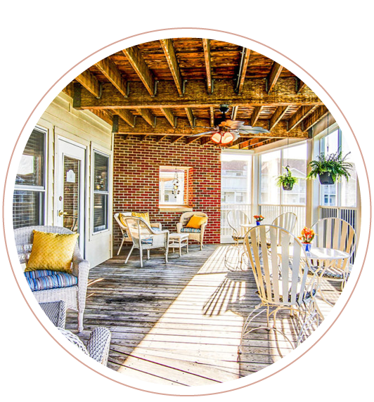 A porch with furniture and a ceiling fan