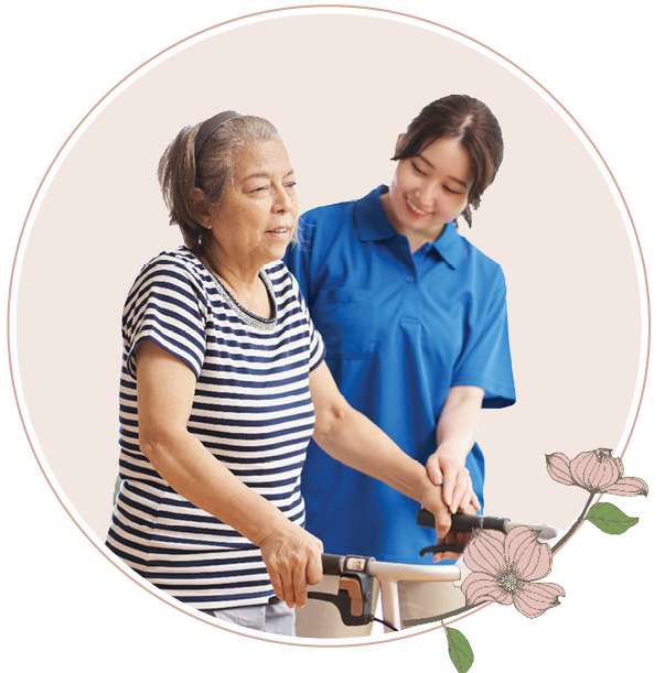 A woman helping an older woman use a walker 