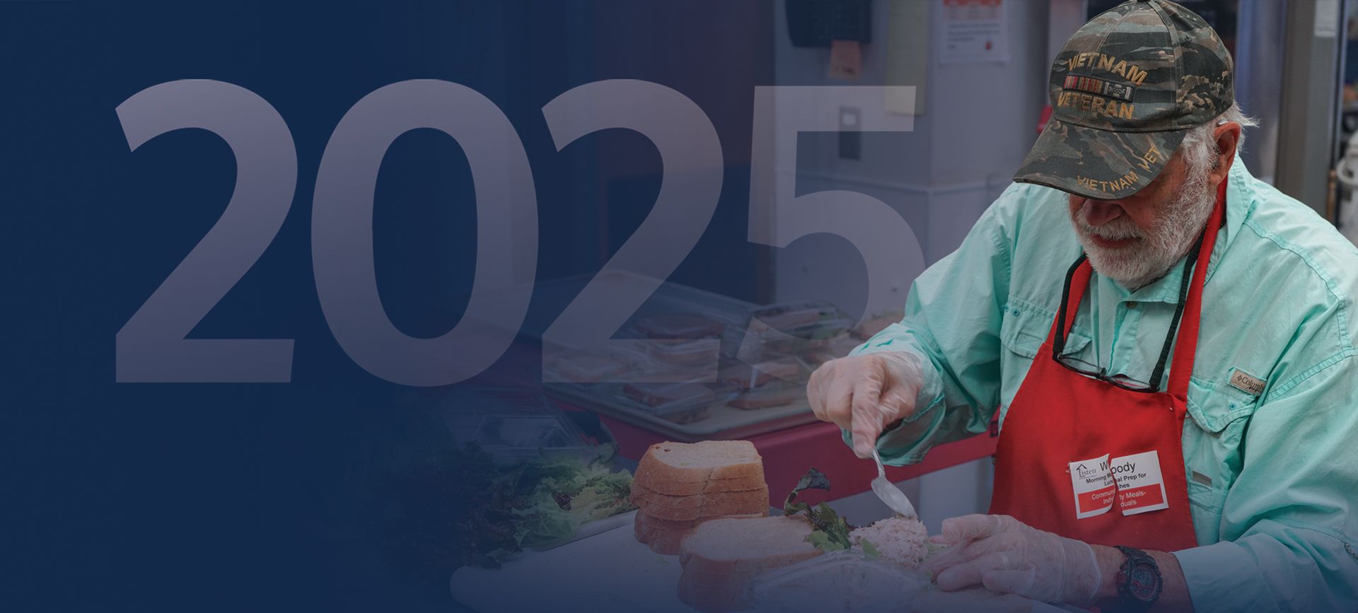 Man in a red apron preparing food, with 