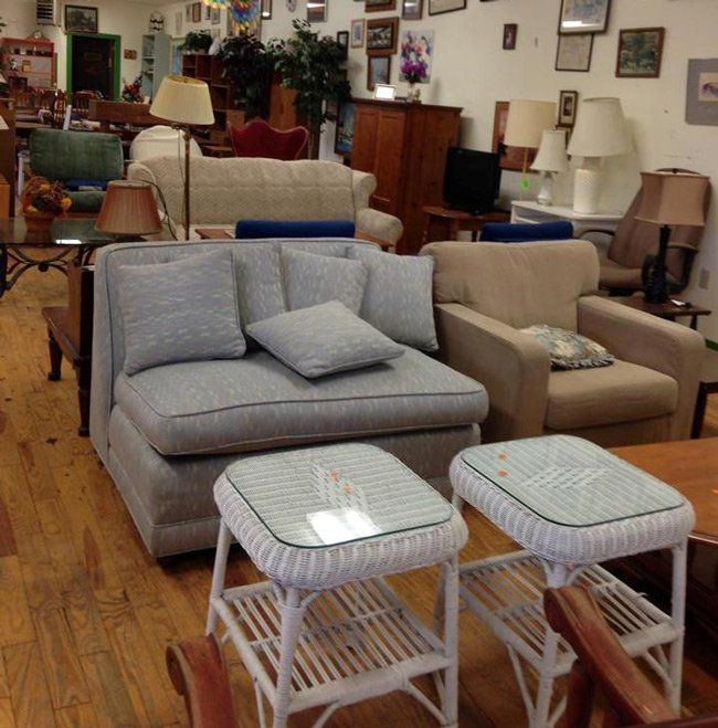 A living room filled with furniture and wicker tables