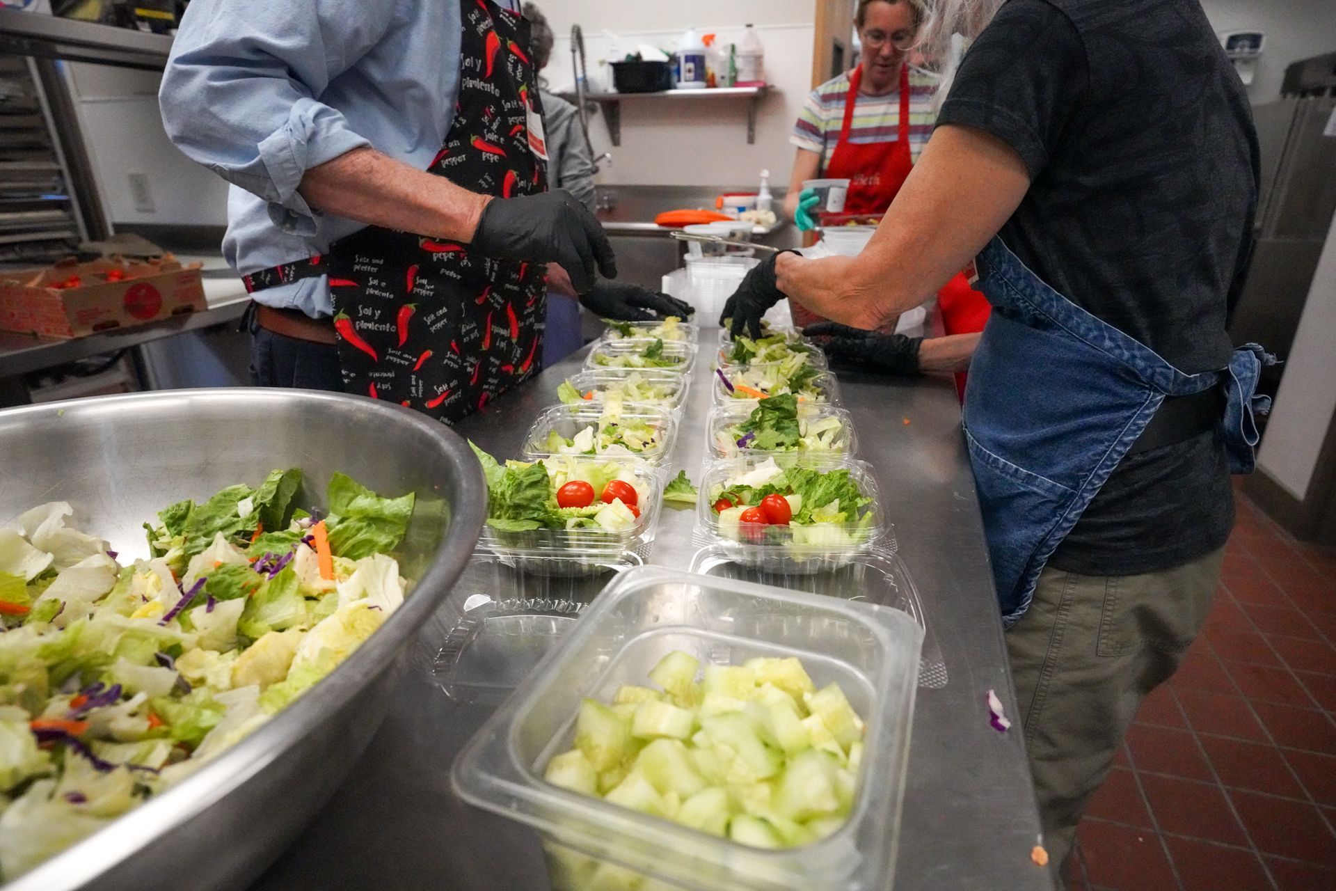 A group of people are preparing food in a kitchen.