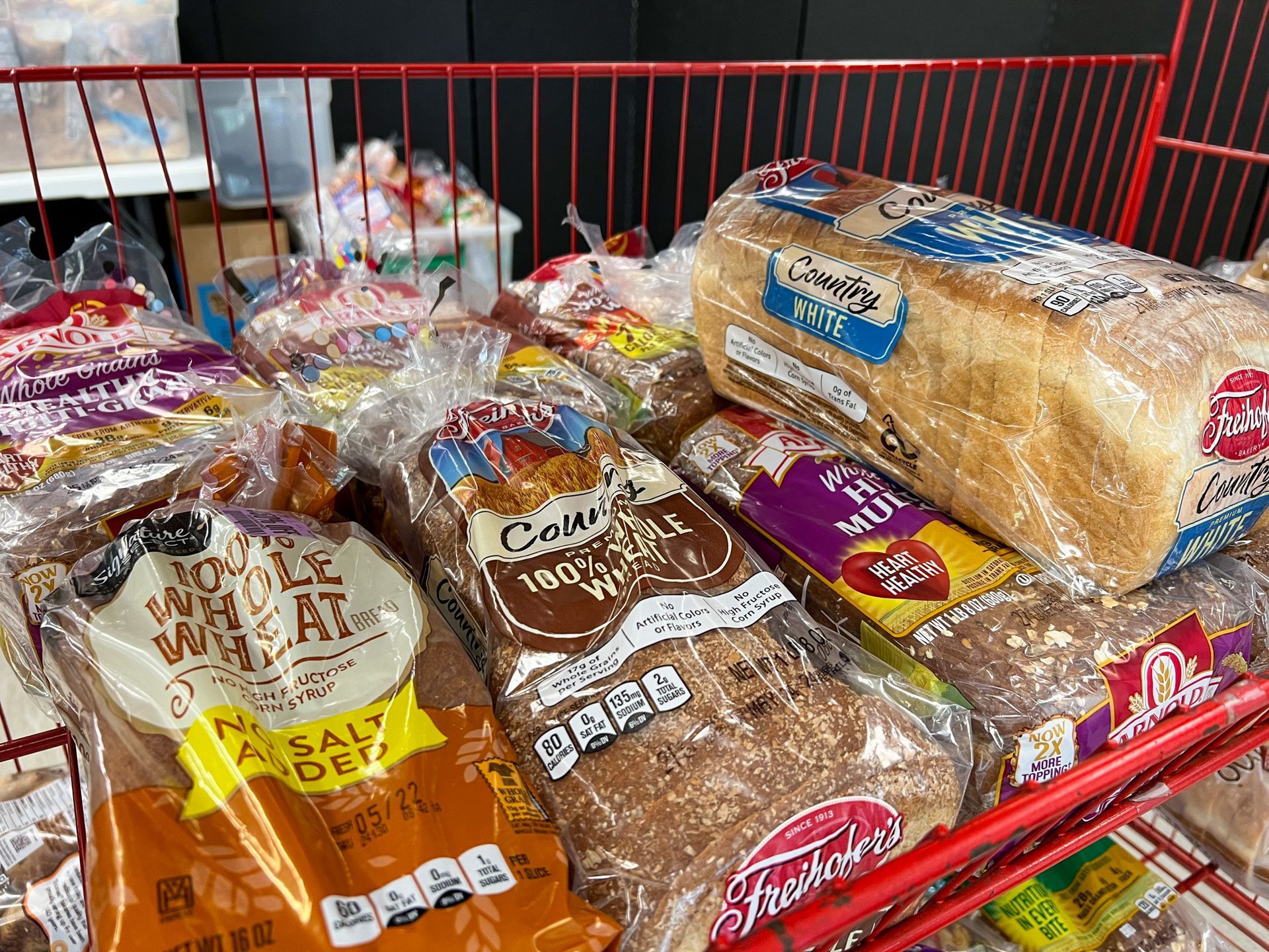 There are many different types of bread on the shelf.