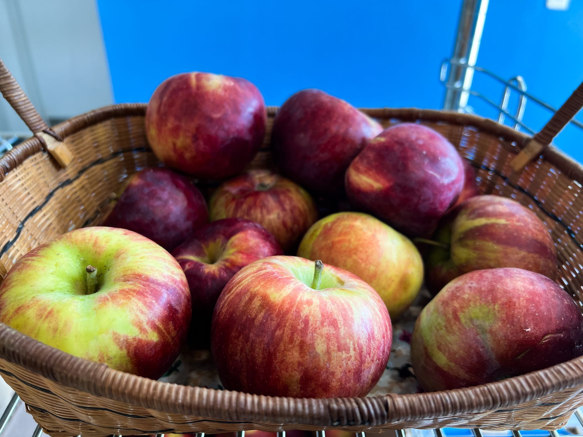 A basket filled with apples is sitting on a table