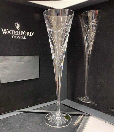 A pair of waterford crystal champagne flutes in a box
