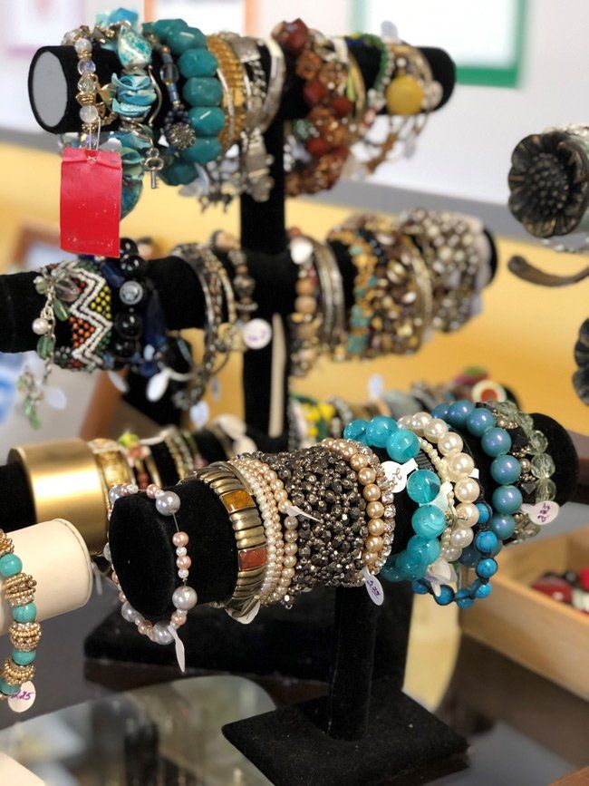 A bunch of bracelets are on display on a stand