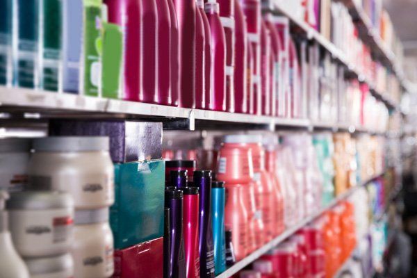 A row of shelves filled with lots of hair products in a store.