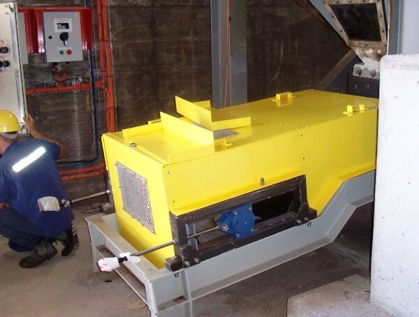 A man is working on a yellow machine in a room - Engineering Tooling In Thornton, NSW