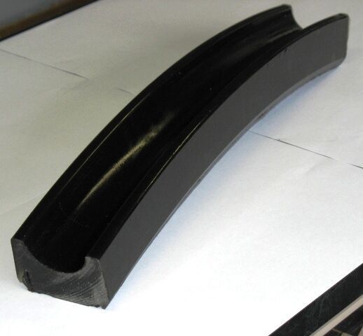 A black piece of rubber is sitting on a white surface - Engineering Tooling In Thornton, NSW